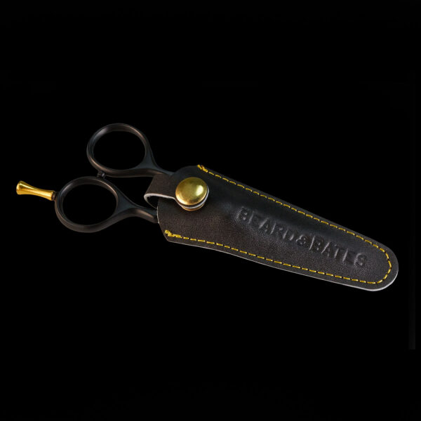 A great set of trimming scissors is a necessity: for this reason Beard & Bates has designed, developed and hand-crafted some of the best shears money can buy. Our 1878 Black Label Shears were inspired by classic 19th Century grooming scissors which were prized possessions carried by cavalry commanders who favored long and intimidating facial hair. Taking a cue from the fact that Cavalry soldiers' tools of the trade were carbines, pistols and sabers, we created a unique embossed genuine leather holster/scabbard to complement these fine shears. The best modern steel is Japanese, and the1878 Black Label Shears are crafted from the finest J2 420 Japanese steel and heat treated to Rockwell Hardness of 55-56. The scissors are 4.5" in total, currently TSA approved for travel, and the blades are razor sharp convex edge blades, which are hollow ground to make precision cuts, and require no resharpening. This quality level is on par with profession hair cutting scissors which cost $250-$500. The traditional ergonomic design enables you to put your ring finger through the hole, use the two indentations to rest your index and middle fingers, all while allowing your pinky to sit atop the brass finger rest. This provides one much more fluid control when trimming. It had become historically common for Calvary forces to wear imposing facial hair, whether it be long mustaches or full beards, so as to appear more imposing to the enemy, and so specific appearance was an important "weapon." Weapon or not, your facial hair will benefit from this quality holstered set of shears.