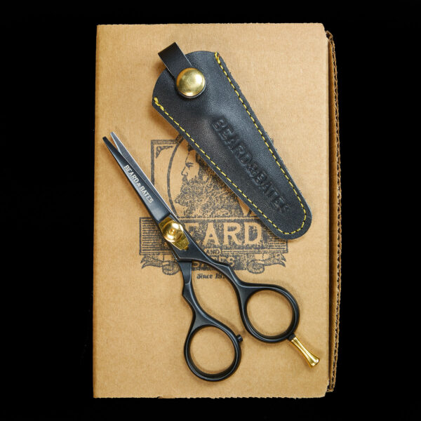 A great set of trimming scissors is a necessity: for this reason Beard & Bates has designed, developed and hand-crafted some of the best shears money can buy. Our 1878 Black Label Shears were inspired by classic 19th Century grooming scissors which were prized possessions carried by cavalry commanders who favored long and intimidating facial hair. Taking a cue from the fact that Cavalry soldiers' tools of the trade were carbines, pistols and sabers, we created a unique embossed genuine leather holster/scabbard to complement these fine shears. The best modern steel is Japanese, and the1878 Black Label Shears are crafted from the finest J2 420 Japanese steel and heat treated to Rockwell Hardness of 55-56. The scissors are 4.5" in total, currently TSA approved for travel, and the blades are razor sharp convex edge blades, which are hollow ground to make precision cuts, and require no resharpening. This quality level is on par with profession hair cutting scissors which cost $250-$500. The traditional ergonomic design enables you to put your ring finger through the hole, use the two indentations to rest your index and middle fingers, all while allowing your pinky to sit atop the brass finger rest. This provides one much more fluid control when trimming. It had become historically common for Calvary forces to wear imposing facial hair, whether it be long mustaches or full beards, so as to appear more imposing to the enemy, and so specific appearance was an important "weapon." Weapon or not, your facial hair will benefit from this quality holstered set of shears.